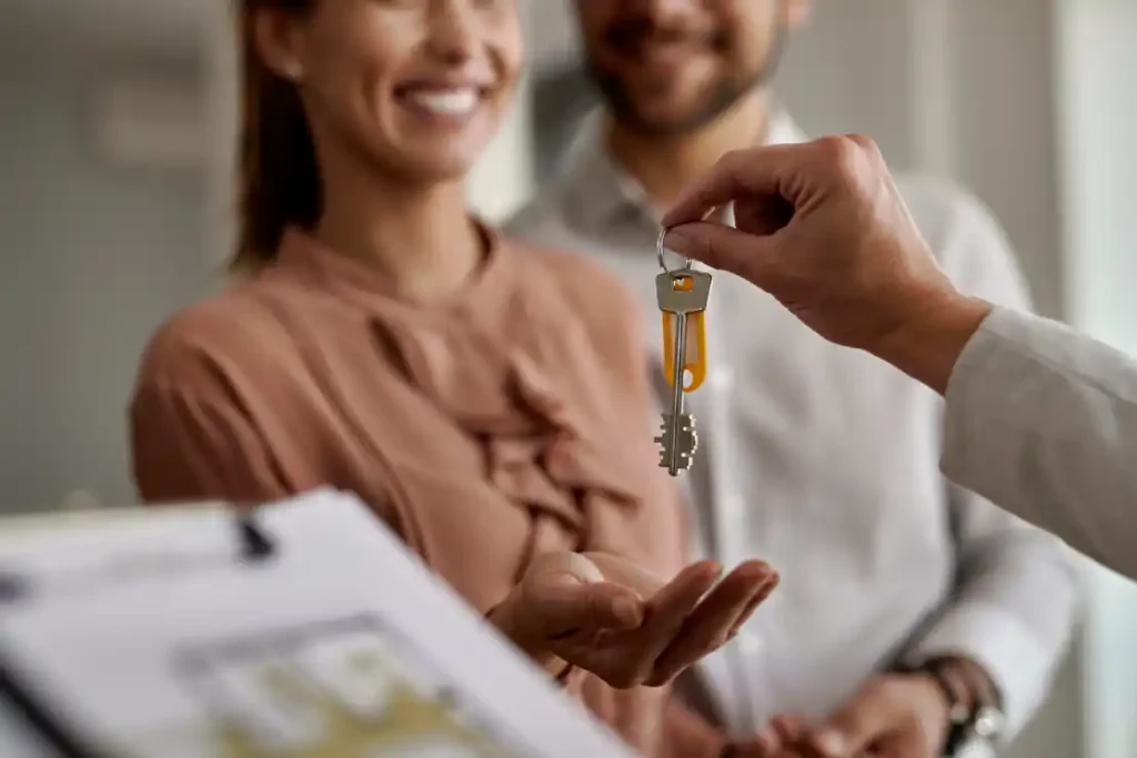 Property maintenance services for holiday homes in Småland, Sweden a person handing a key to a woman